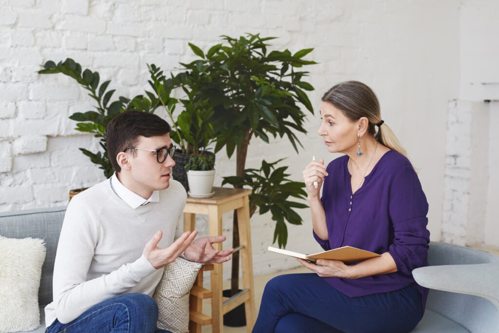 An adult speaking with a counselor